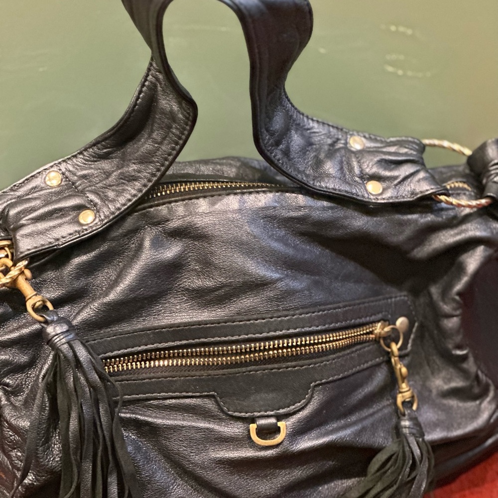 It’s a very soft bag very good size blue and very light weigh